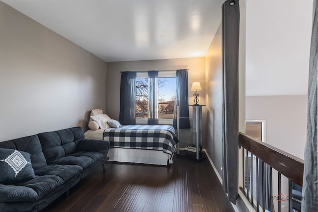 bedroom with dark hardwood / wood-style floors