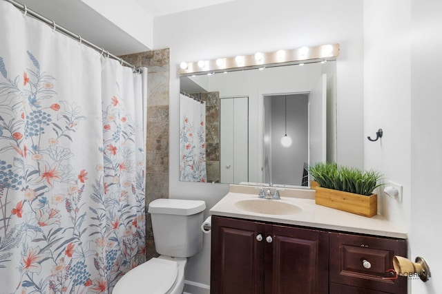 bathroom with vanity, a shower with curtain, and toilet