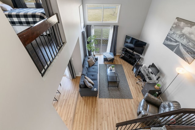 living room featuring hardwood / wood-style floors and a high ceiling