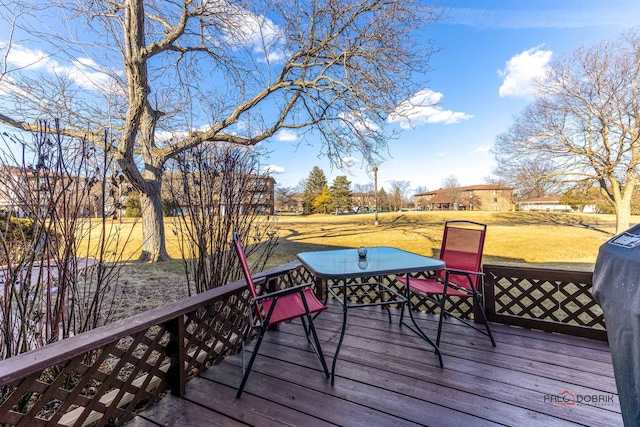 wooden terrace with a lawn