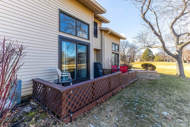 view of side of home with a lawn