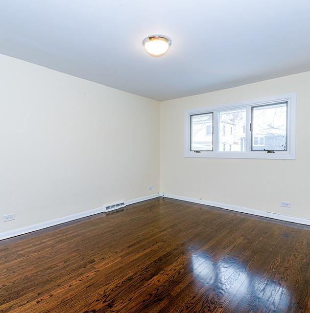 unfurnished room with dark hardwood / wood-style flooring