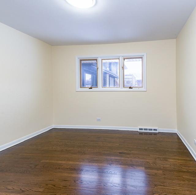 unfurnished room with dark hardwood / wood-style floors