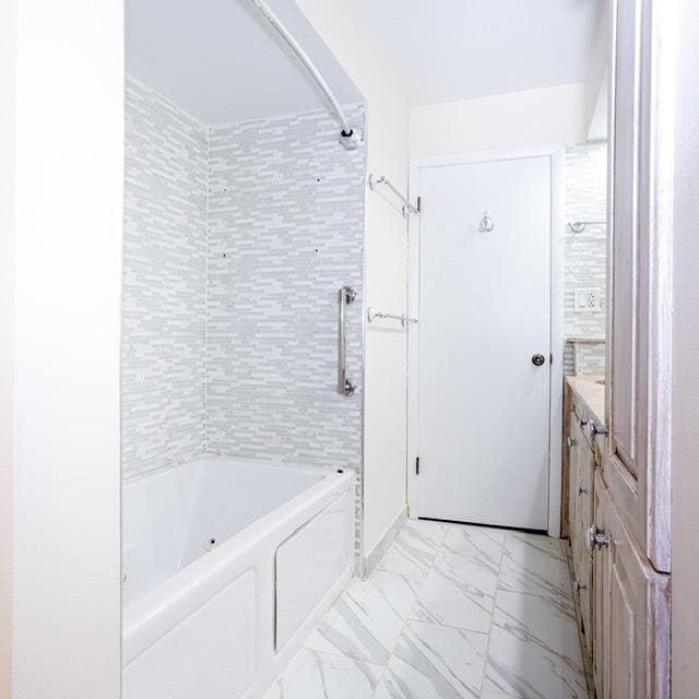 bathroom featuring vanity and washtub / shower combination