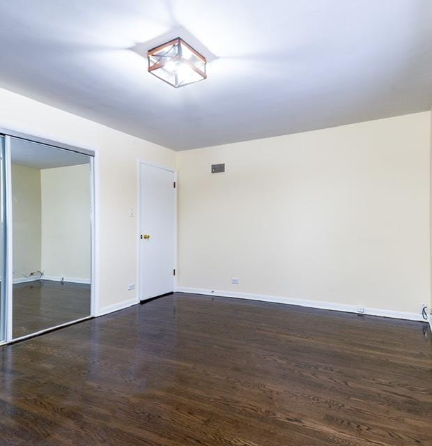 unfurnished room featuring dark wood-type flooring