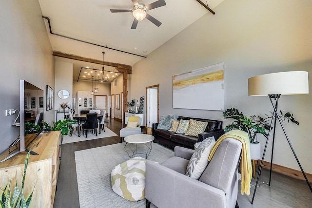 living room with ceiling fan with notable chandelier, high vaulted ceiling, and hardwood / wood-style flooring