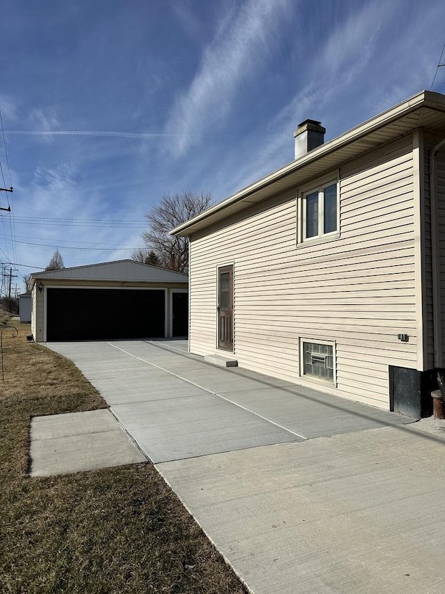 view of side of property featuring an outbuilding and a garage