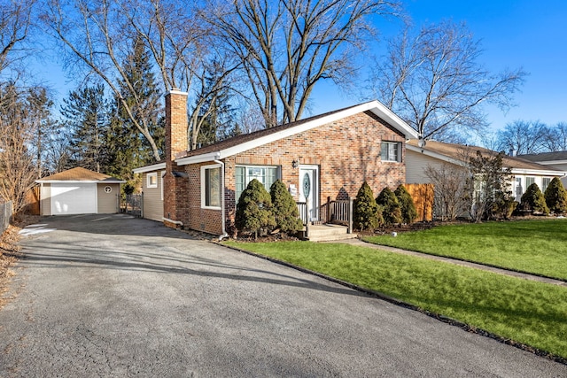 view of front of home with a garage, an outdoor structure, and a front yard