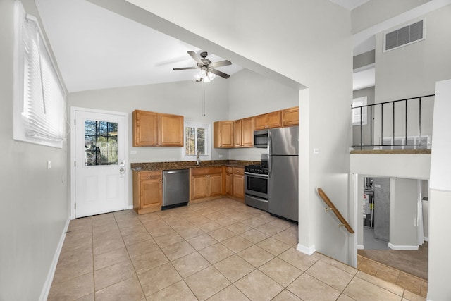 kitchen featuring light tile patterned flooring, appliances with stainless steel finishes, high vaulted ceiling, and ceiling fan