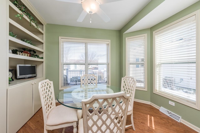 dining area with ceiling fan and wood-type flooring