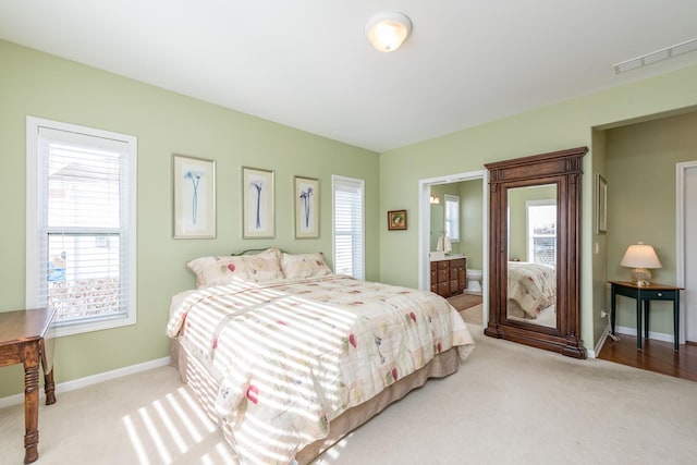 carpeted bedroom with ensuite bath