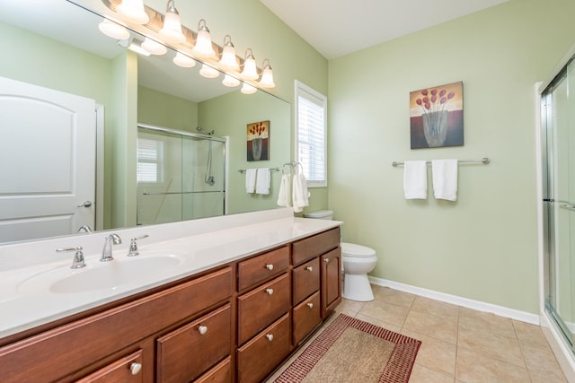 bathroom with an enclosed shower, vanity, tile patterned flooring, and toilet