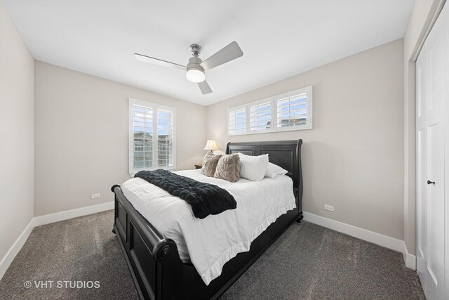 bedroom with a closet, baseboards, dark carpet, and a ceiling fan