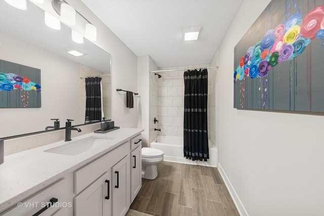 bathroom with toilet, shower / bath combo with shower curtain, wood tiled floor, vanity, and baseboards