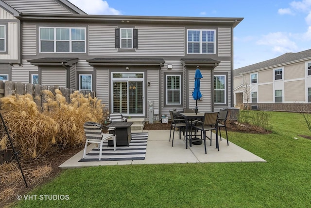 rear view of house with a lawn and a patio area