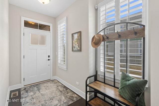 foyer entrance featuring baseboards