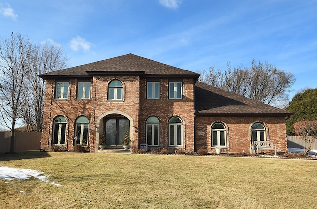 exterior space featuring a front yard and french doors