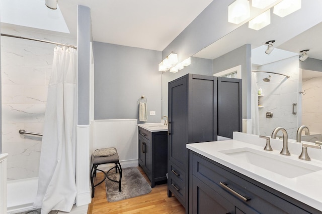 bathroom with vanity, hardwood / wood-style floors, and walk in shower