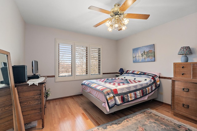 bedroom with hardwood / wood-style flooring and ceiling fan