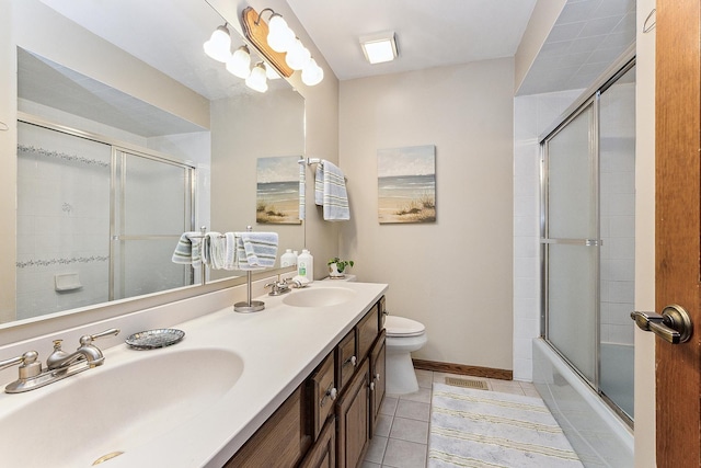 full bathroom with enclosed tub / shower combo, tile patterned floors, toilet, and vanity