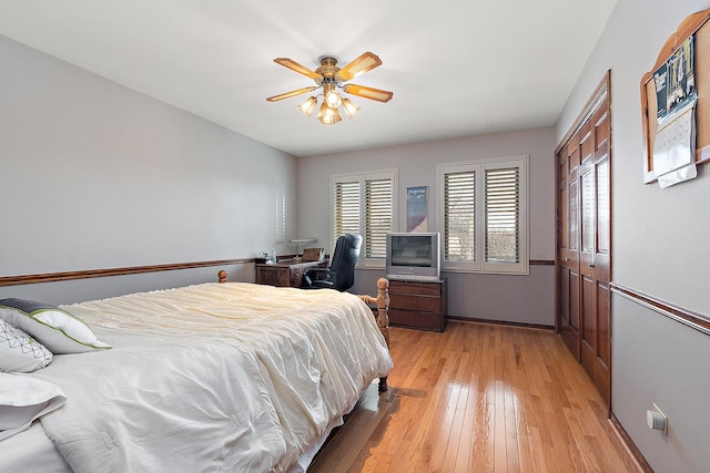 bedroom with ceiling fan and light hardwood / wood-style floors