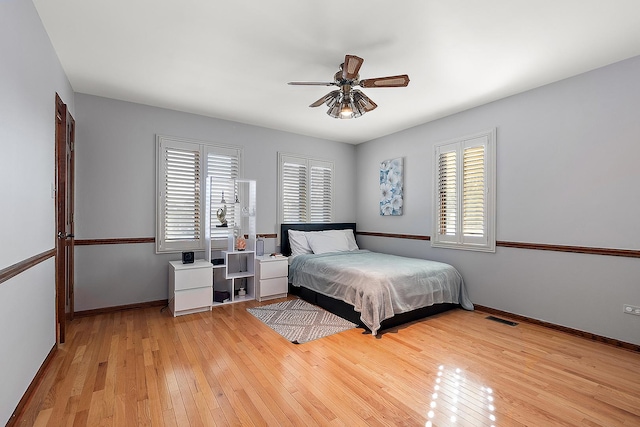 bedroom with ceiling fan and light hardwood / wood-style floors