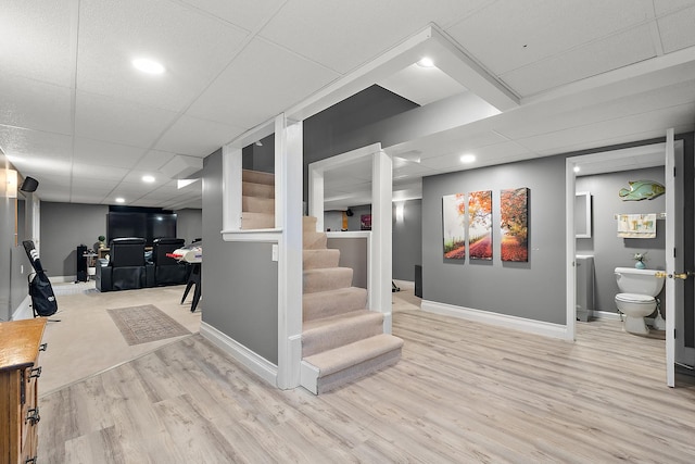 interior space featuring hardwood / wood-style flooring and a drop ceiling