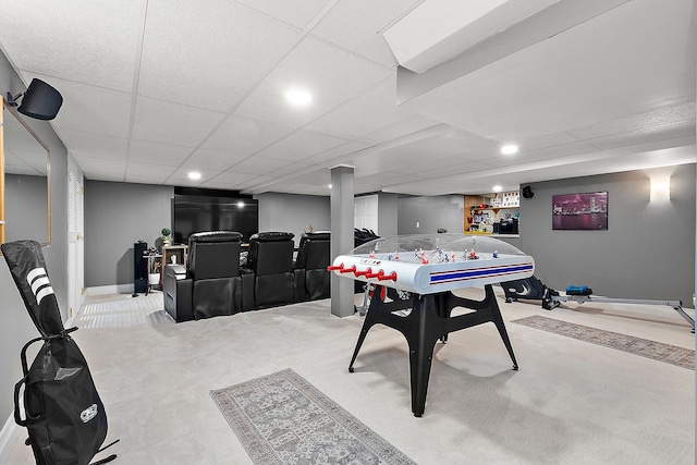 game room with light carpet and a drop ceiling