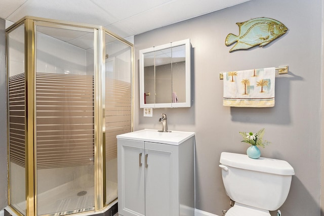 bathroom with vanity, a shower with shower door, and toilet