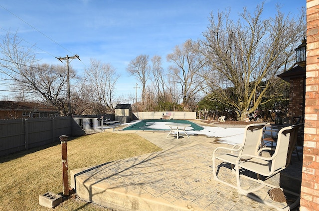 view of swimming pool with a yard and a patio