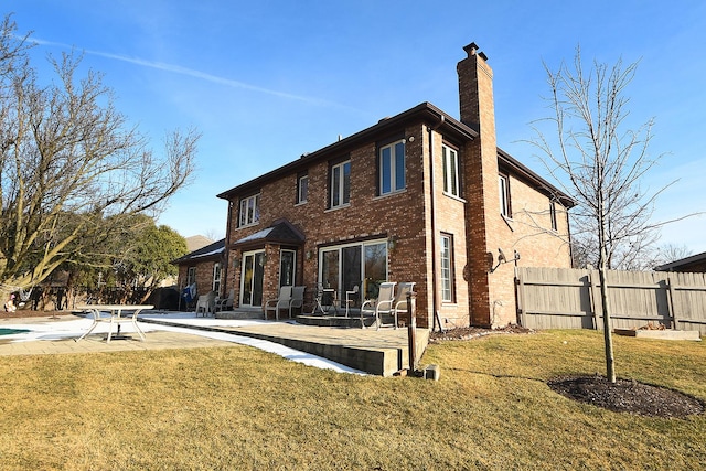 rear view of property with a patio area and a lawn