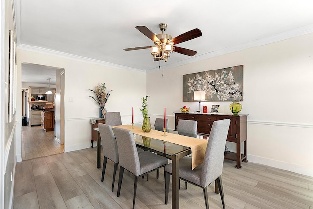 dining space with ornamental molding, light hardwood / wood-style floors, and ceiling fan