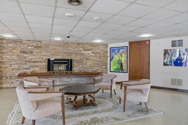 living room featuring a drop ceiling