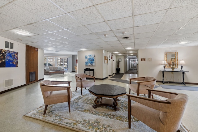 living room featuring a drop ceiling