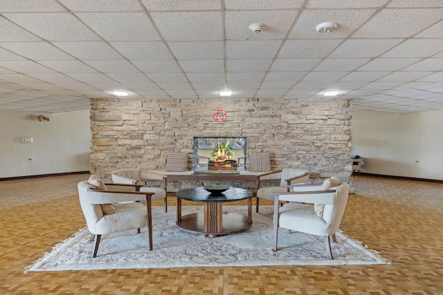 dining area featuring parquet flooring and a paneled ceiling