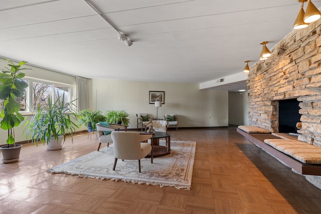 living room with parquet flooring and a fireplace