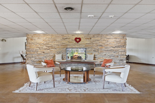 unfurnished dining area with a drop ceiling