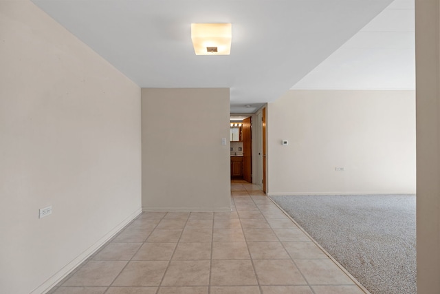 hallway featuring light carpet