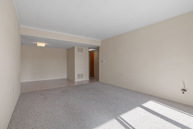 spare room featuring light colored carpet