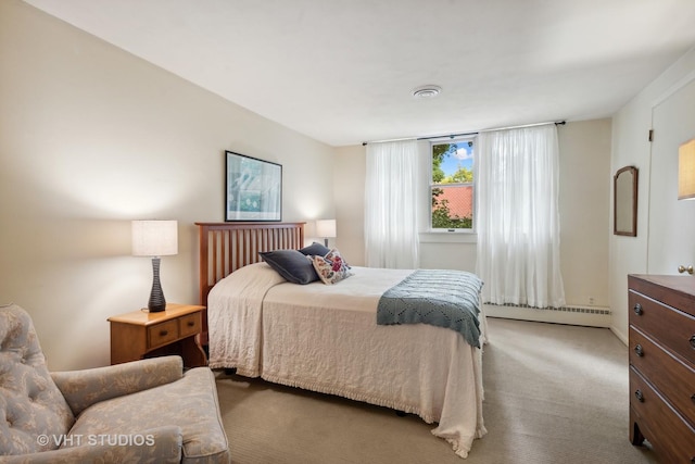 bedroom with carpet and a baseboard heating unit