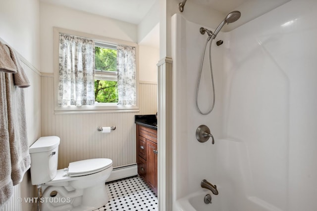 bathroom featuring wooden walls, a baseboard radiator, vanity, and toilet