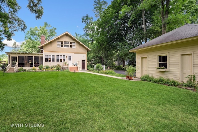 back of property featuring a yard and a sunroom