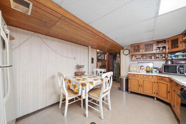 dining area with a paneled ceiling