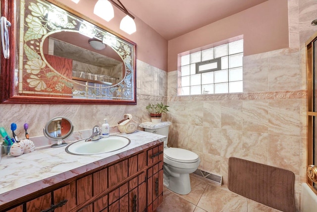 bathroom featuring tile patterned flooring, vanity, tile walls, and toilet