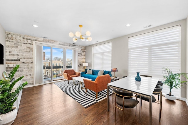 living room featuring dark wood-type flooring and a chandelier