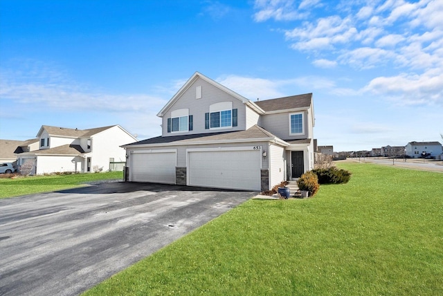 view of property with a garage and a front yard