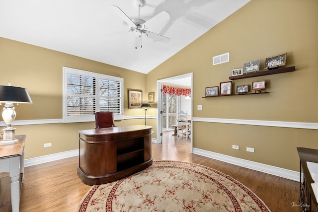 home office with hardwood / wood-style flooring, ceiling fan, a healthy amount of sunlight, and vaulted ceiling