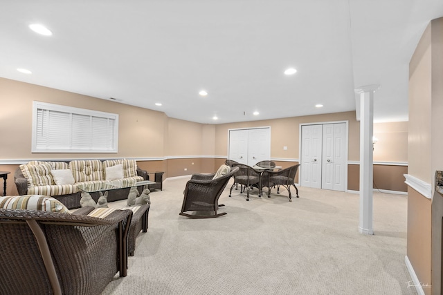 carpeted living room featuring decorative columns