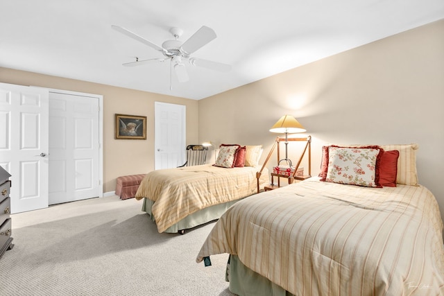 bedroom featuring light colored carpet and ceiling fan