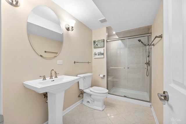 bathroom featuring walk in shower, sink, toilet, and tile patterned flooring